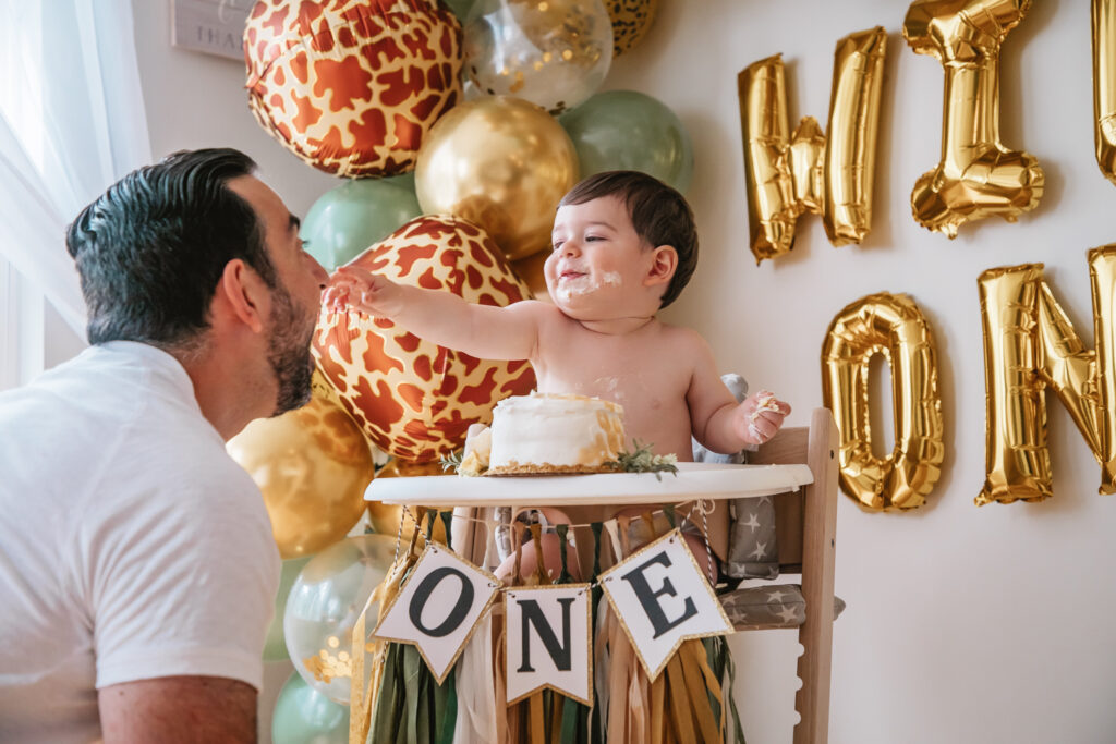 Luca is One! Wild One First Birthday Party - All the details of Luca's Wild One Safari Themed First Birthday. Wild One balloon backdrop. Safari balloon garland. Baby's first birthday smash cake.