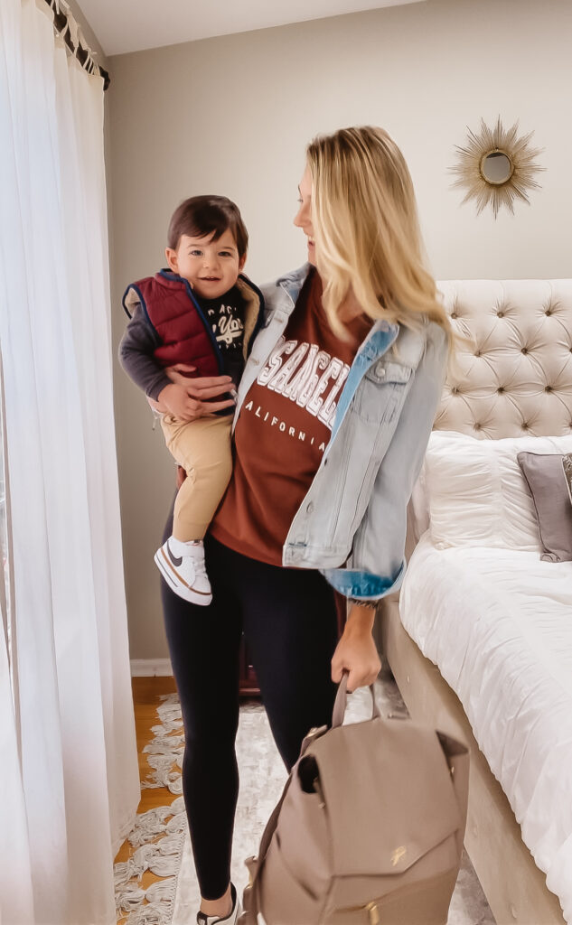 Fall Outfit Inspo: 7 Coordinating Mommy & Me Styles. Toddler boy fall outfit. Toddler NY sweatshirt, reversible puffy vest, vintage wash joggers & toddler Nike sneakers. Women's Los Angeles crew neck sweatshirt, basic black leggings or joggers, vintage wash denim jacket, chic leather diaper bag backpack & black and white new balance sneakers.