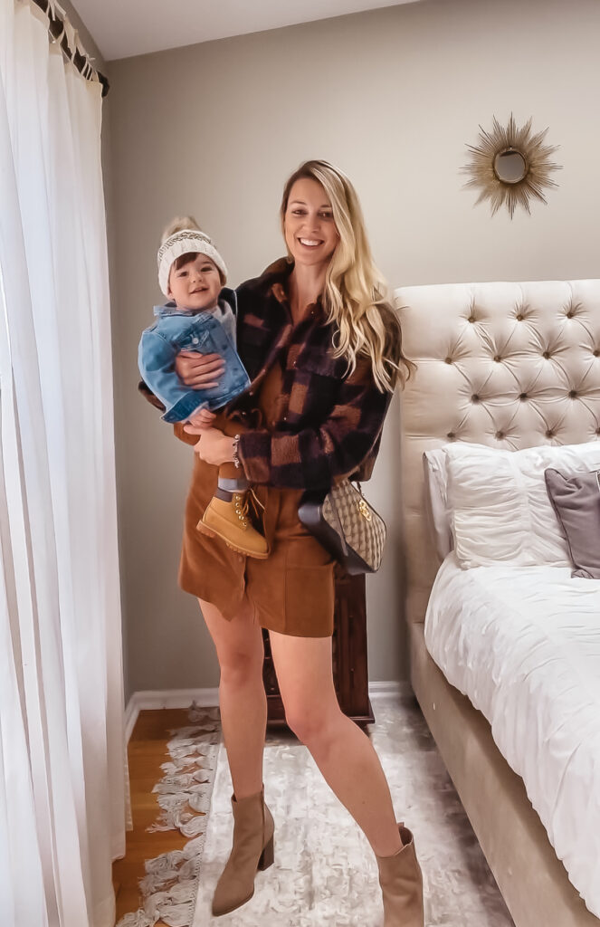 Fall Outfit Inspo: 7 Coordinating Mommy & Me Styles. Toddler boy fall outfit. Toddler marled gray pullover sweatshirt, toddler denim jacket, baby boy corduroy pants, toddler Timberland boots & knit pom beanie for babies and kids. Women's suede mini dress, plaid cropped sherpa bomber, Gucci GG Marmont bag & tan suede booties.