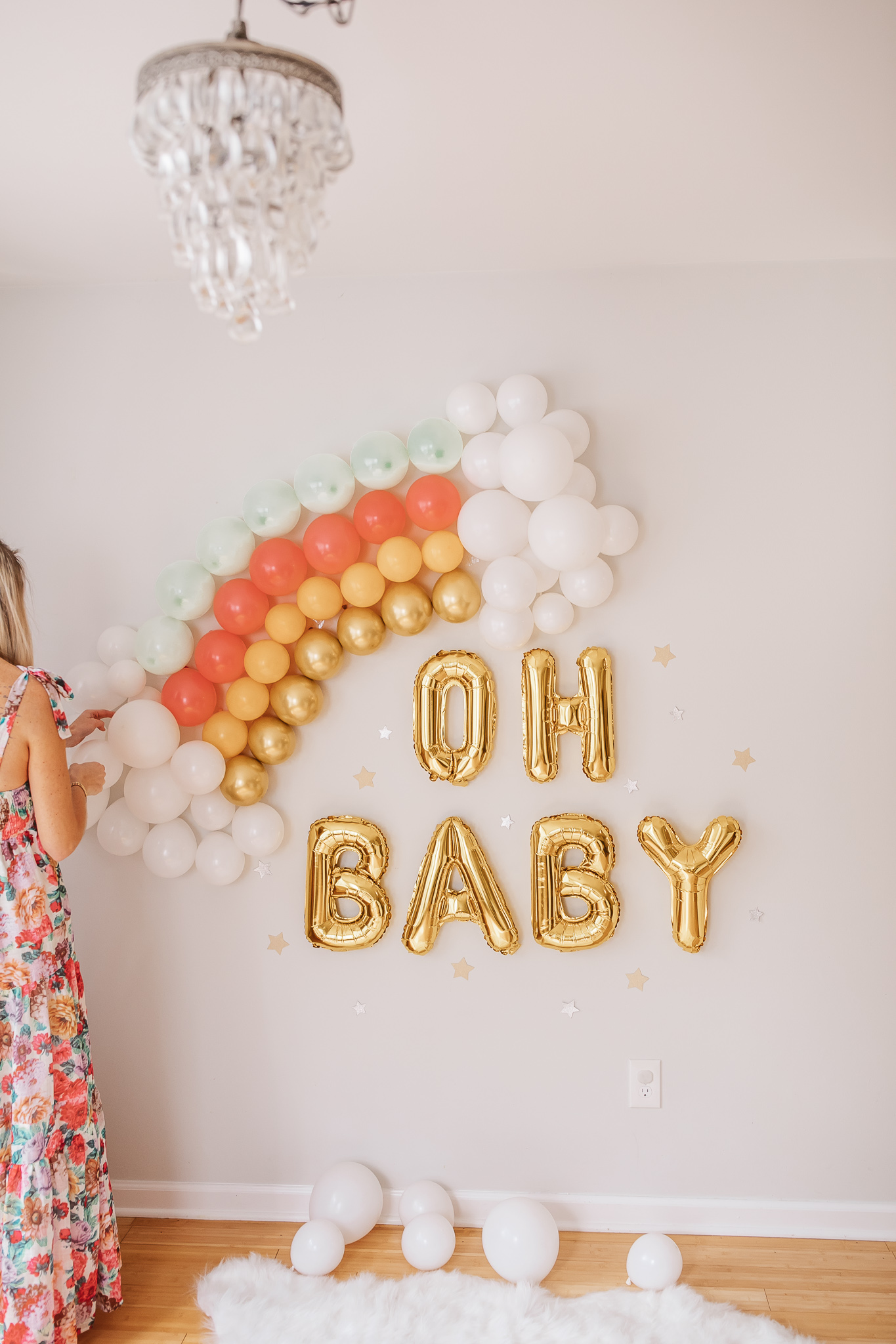DIY Rainbow Baby Pregnancy Announcement. How to create a rainbow balloon wall for a pregnancy announcement. Rainbow baby balloon backdrop for photos.