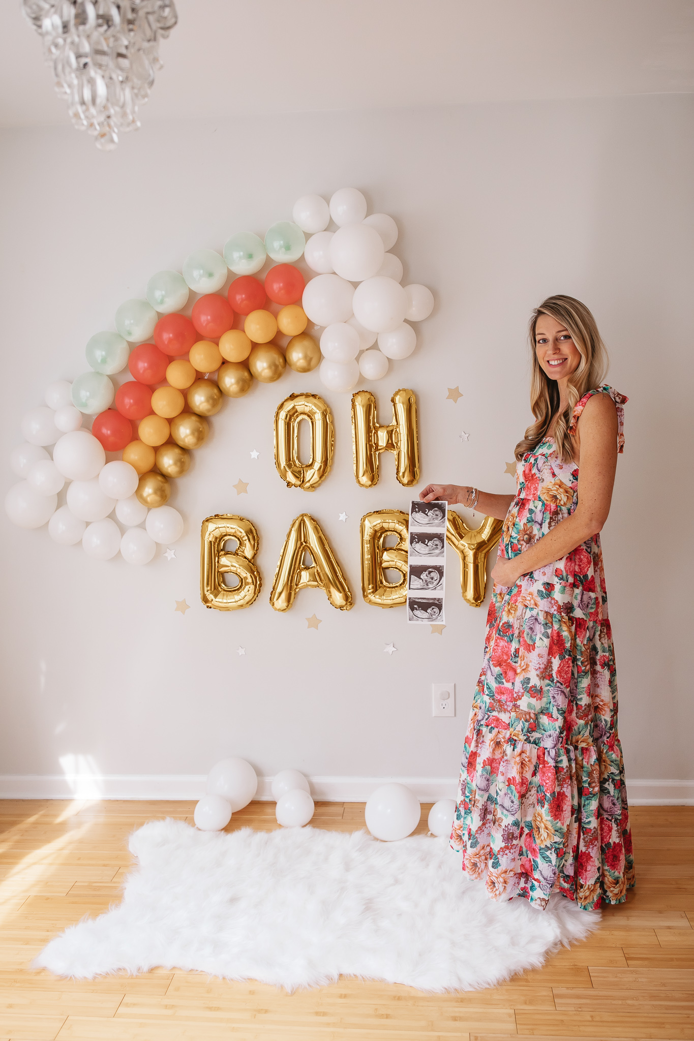 DIY Rainbow Baby Pregnancy Announcement. Mommy to be with the ultrasound. Rainbow baby balloon backdrop for photos.