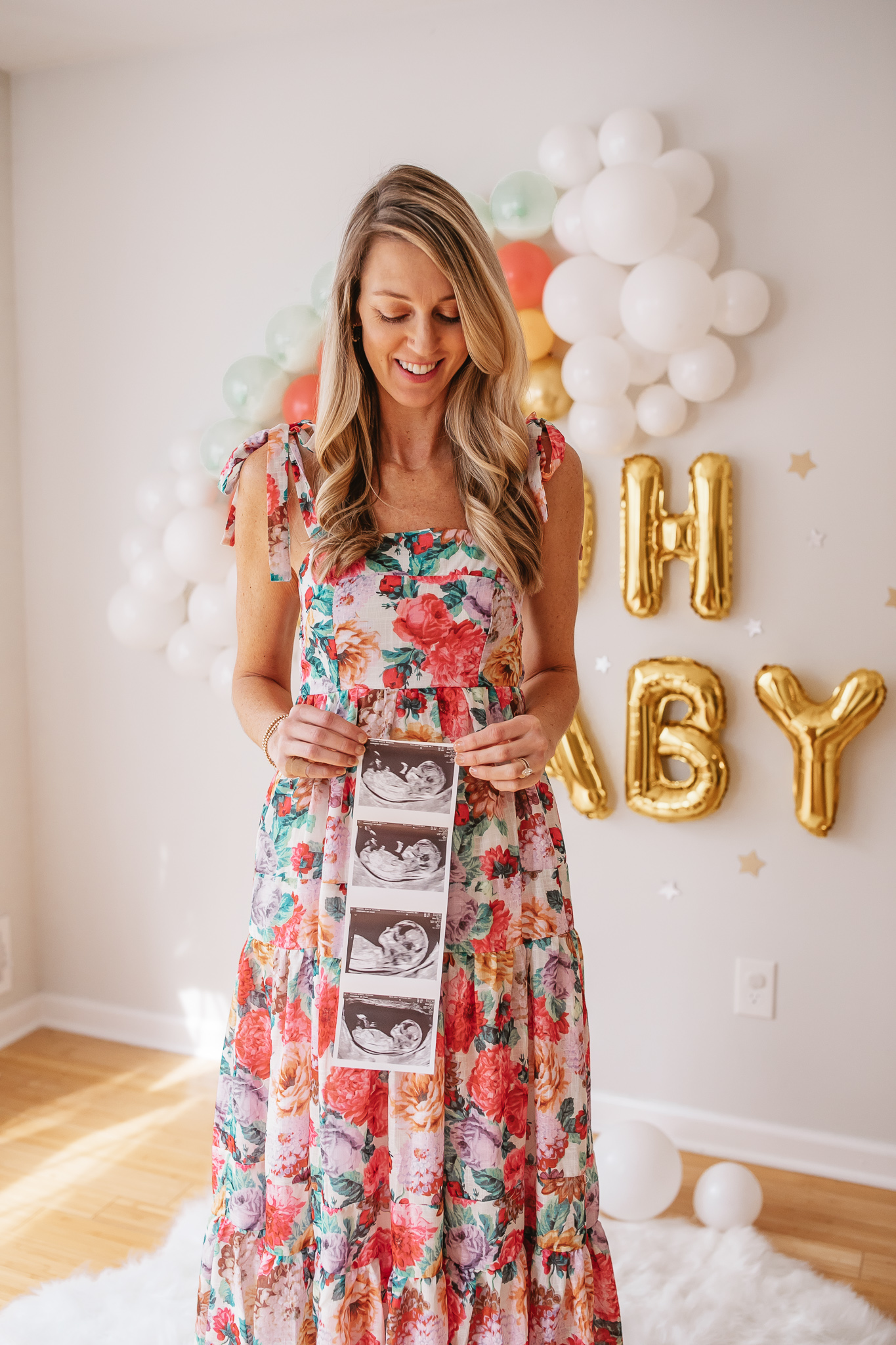 DIY Rainbow Baby Pregnancy Announcement. Mommy to be with the ultrasound. Rainbow baby balloon backdrop for photos.