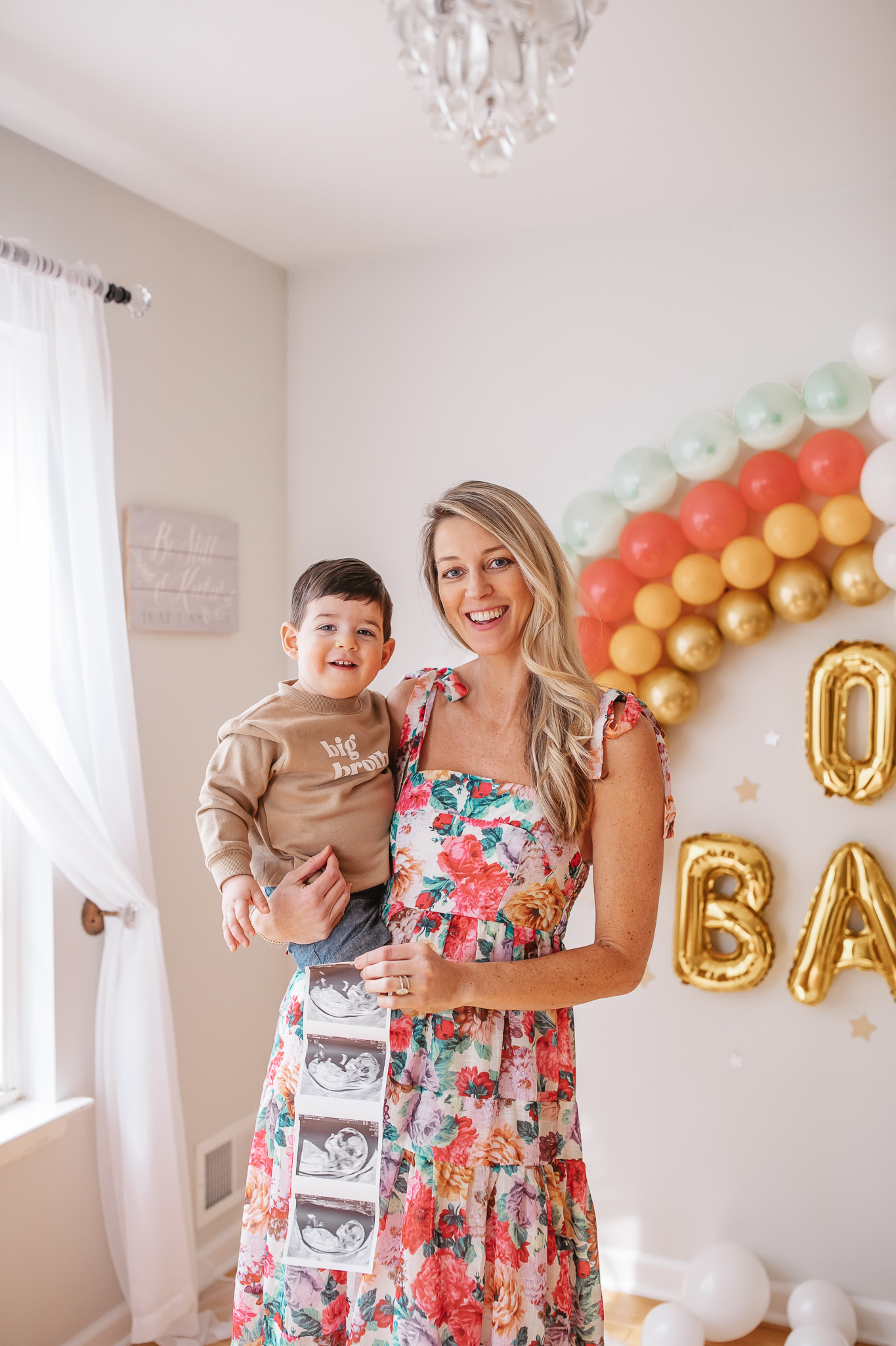 DIY Rainbow Baby Pregnancy Announcement. Mommy to be and big brother with the ultrasound. Rainbow baby balloon backdrop for photos.