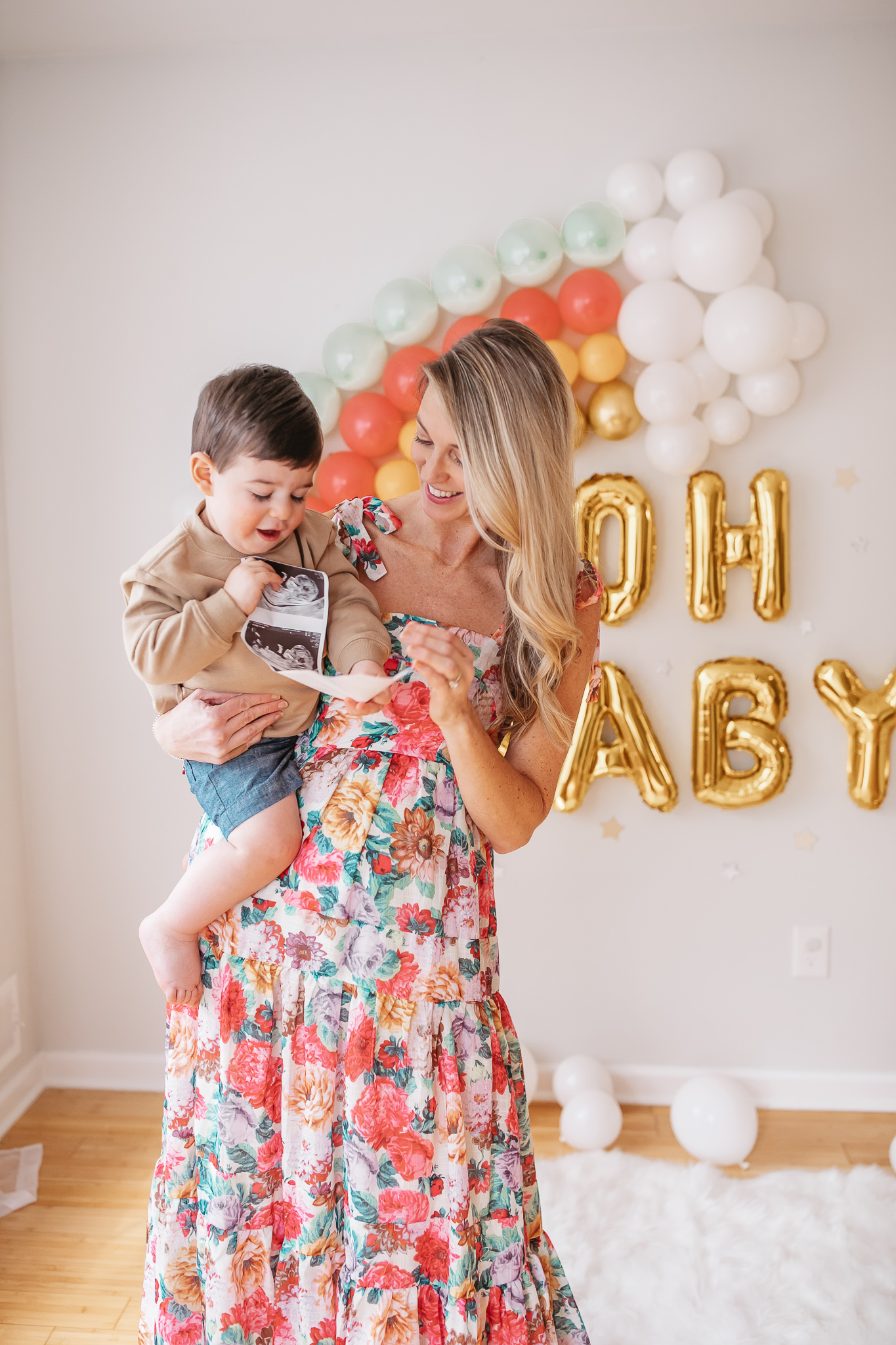 DIY Rainbow Baby Pregnancy Announcement. Mommy to be and big brother with the ultrasound. Rainbow baby balloon backdrop for photos.