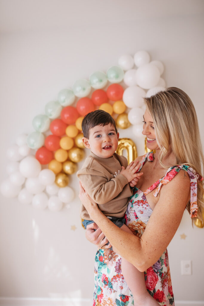 DIY Rainbow Baby Pregnancy Announcement. Rainbow balloon wall pregnancy announcement. Rainbow baby balloon backdrop for photos.