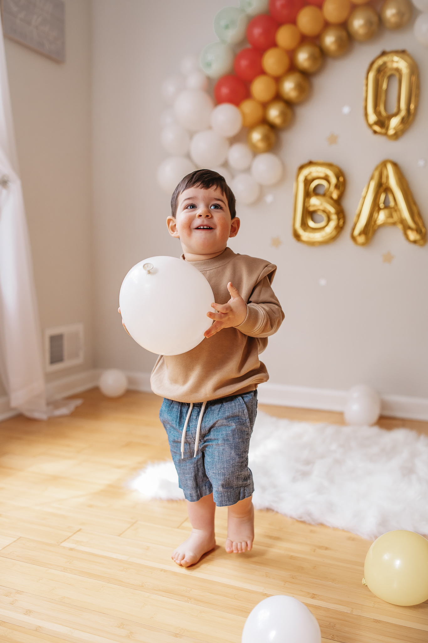 DIY Rainbow Baby Pregnancy Announcement. Big brother sweatshirt. Rainbow baby balloon backdrop for photos.