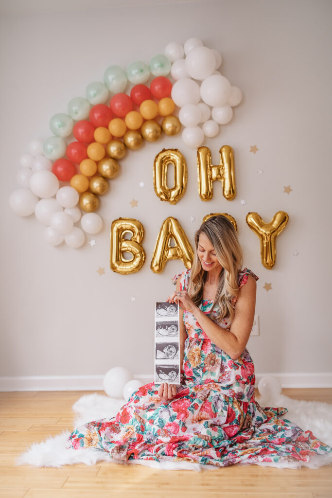 DIY Rainbow Baby Pregnancy Announcement. Rainbow balloon wall pregnancy announcement. Rainbow baby balloon backdrop for photos.