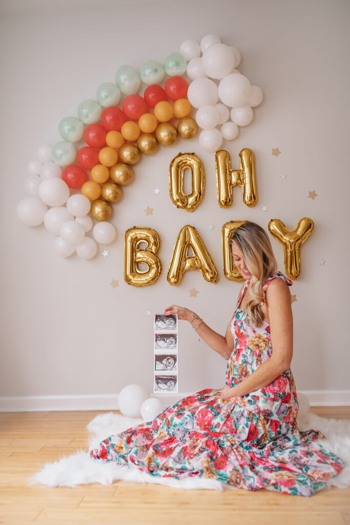DIY Rainbow Baby Pregnancy Announcement. Rainbow balloon wall pregnancy announcement. Rainbow baby balloon backdrop for photos.