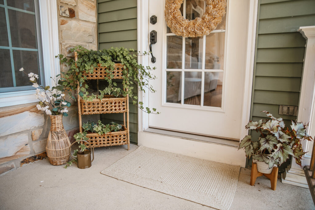 Neutral Front Porch Decor - Create a Front Porch Oasis. Hanging porch swing and oversized outdoor sofa. Hanging planters. Outdoor pillows. Natural materials and greenery.