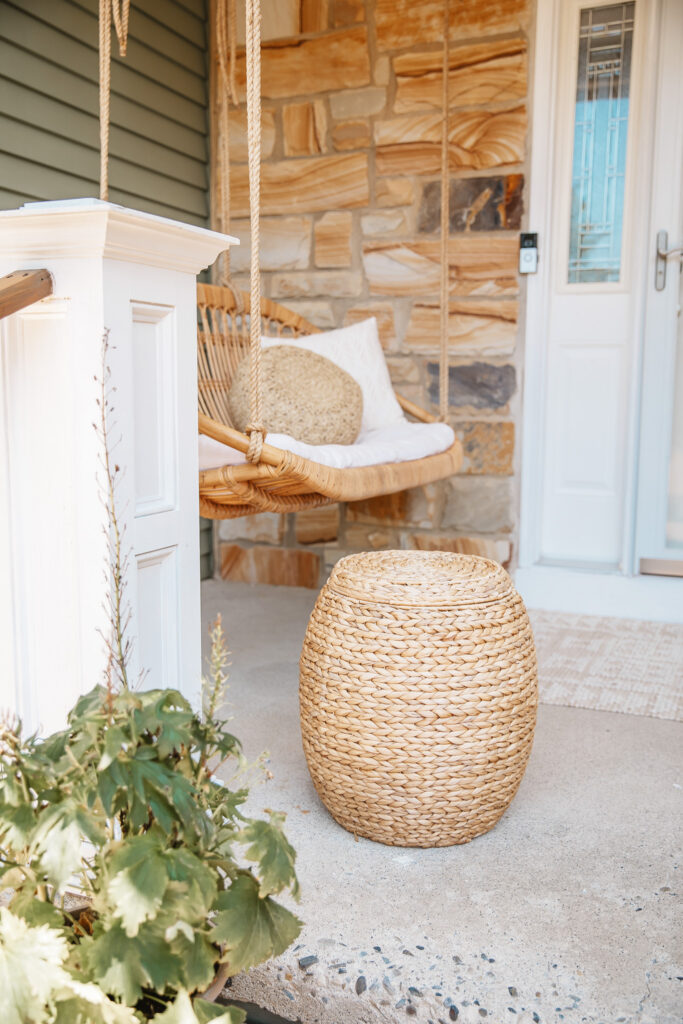 Neutral Front Porch Decor - Create a Front Porch Oasis. Hanging porch swing and oversized outdoor sofa. Hanging planters. Outdoor pillows. Natural materials and greenery.