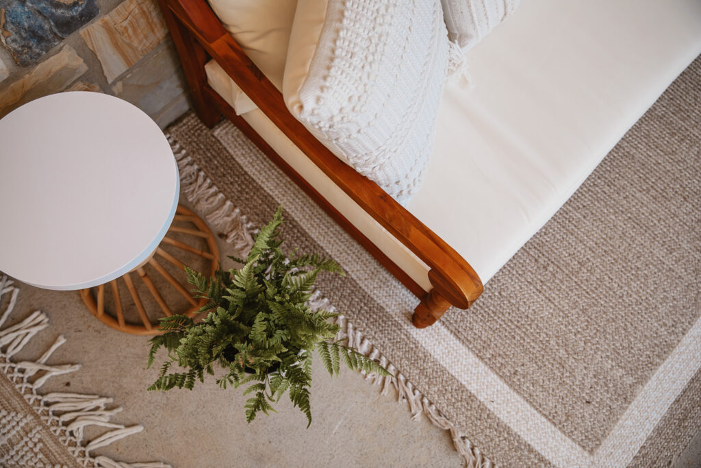 Neutral Front Porch Decor - Create a Front Porch Oasis. Hanging porch swing and oversized outdoor sofa. Hanging planters. Outdoor pillows. Natural materials and greenery.