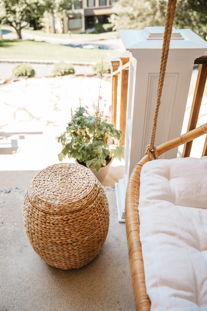 Neutral Front Porch Decor - Create a Front Porch Oasis. Hanging porch swing and oversized outdoor sofa. Hanging planters. Outdoor pillows. Natural materials and greenery.