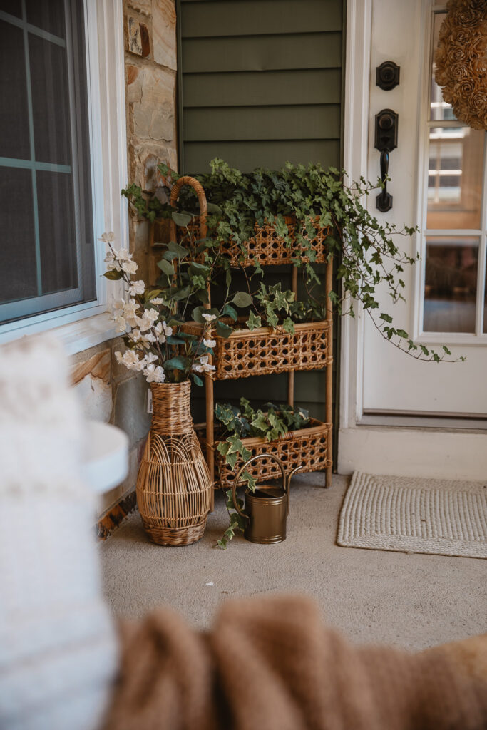 Neutral Front Porch Decor - Create a Front Porch Oasis. Hanging porch swing and oversized outdoor sofa. Hanging planters. Outdoor pillows. Natural materials and greenery.