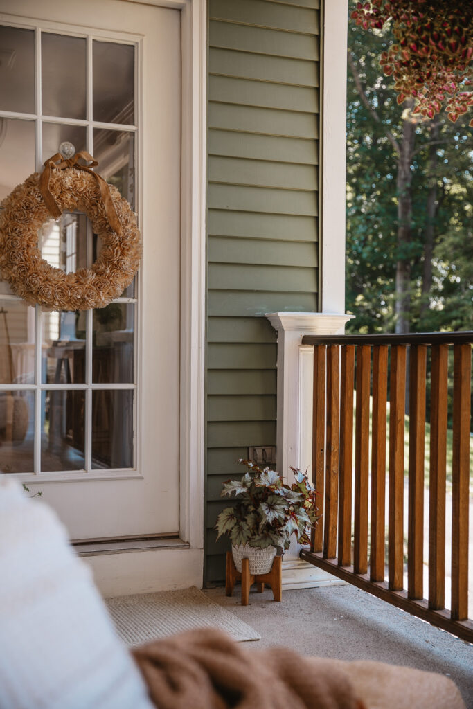 Neutral Front Porch Decor - Create a Front Porch Oasis. Hanging porch swing and oversized outdoor sofa. Hanging planters. Outdoor pillows. Natural materials and greenery.