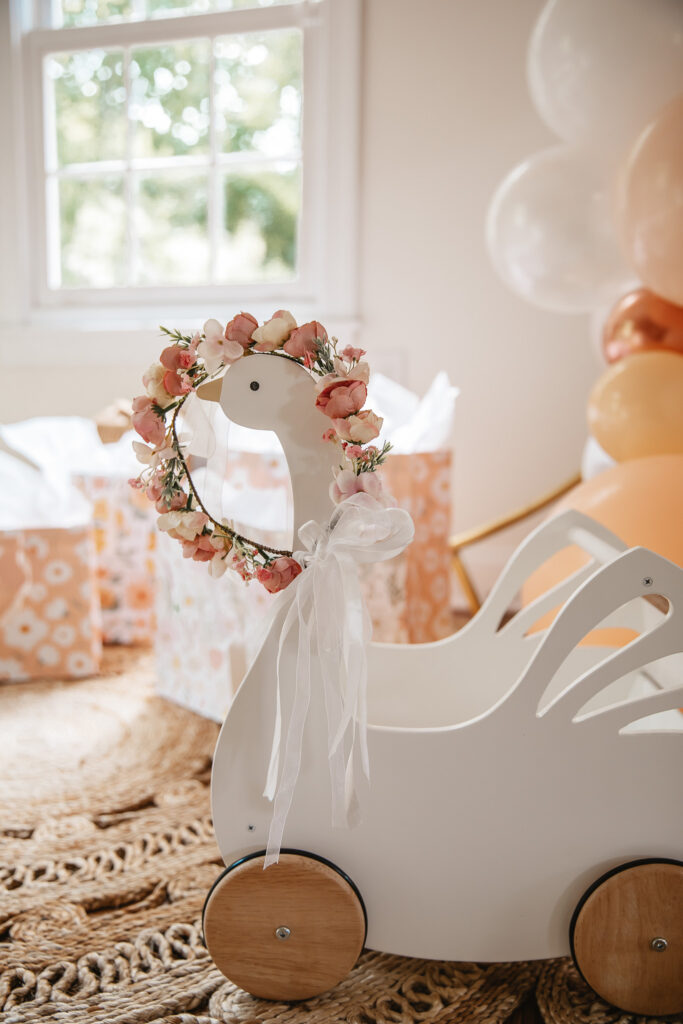 Isn't She ONEderful Boho First Birthday Cake Smash Inspo. Boho baby girl birthday. boho balloon garland. baby girl boho style onesie and flower crown. baby doll pram.